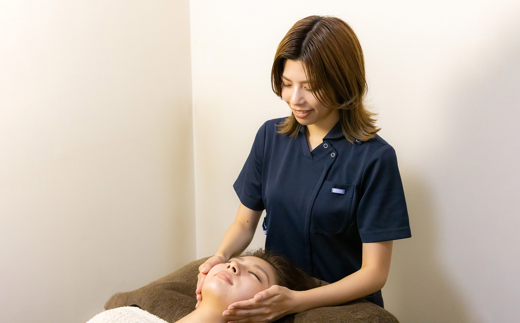 美容整骨で腰部分の施術をするセラピスト